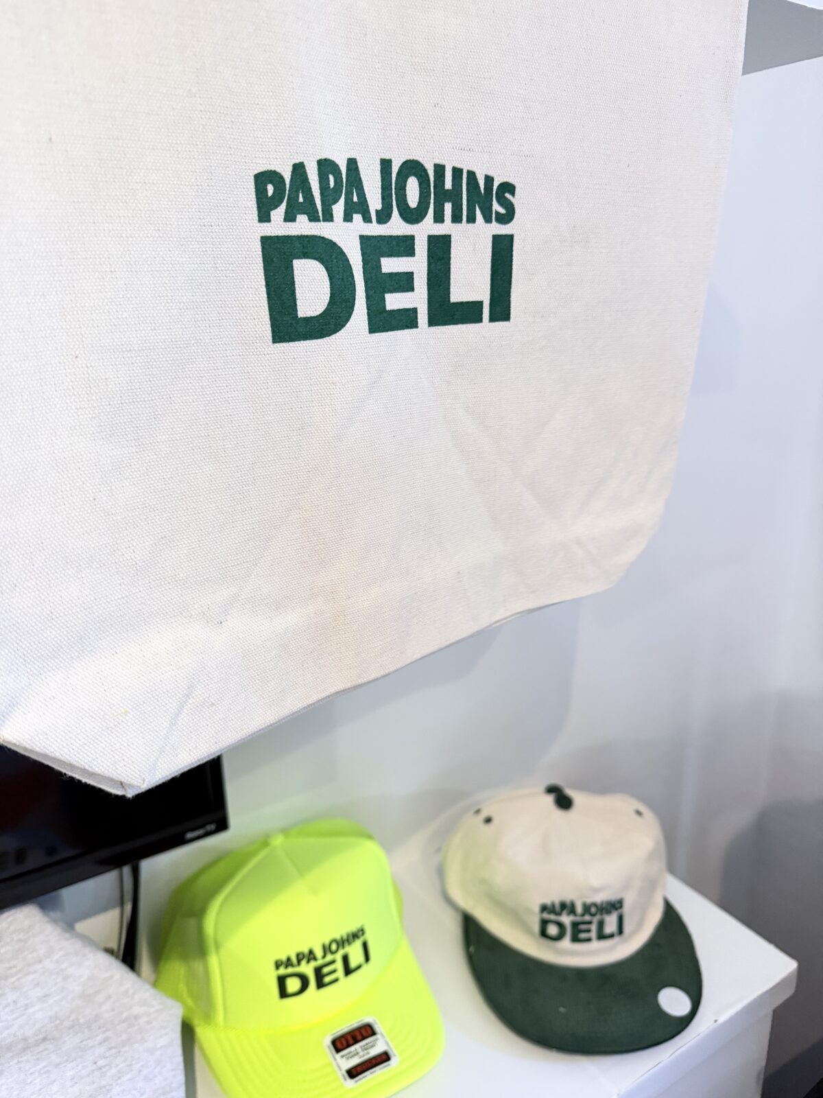 Embroidered tote and caps flat-lay from a brand pop-up