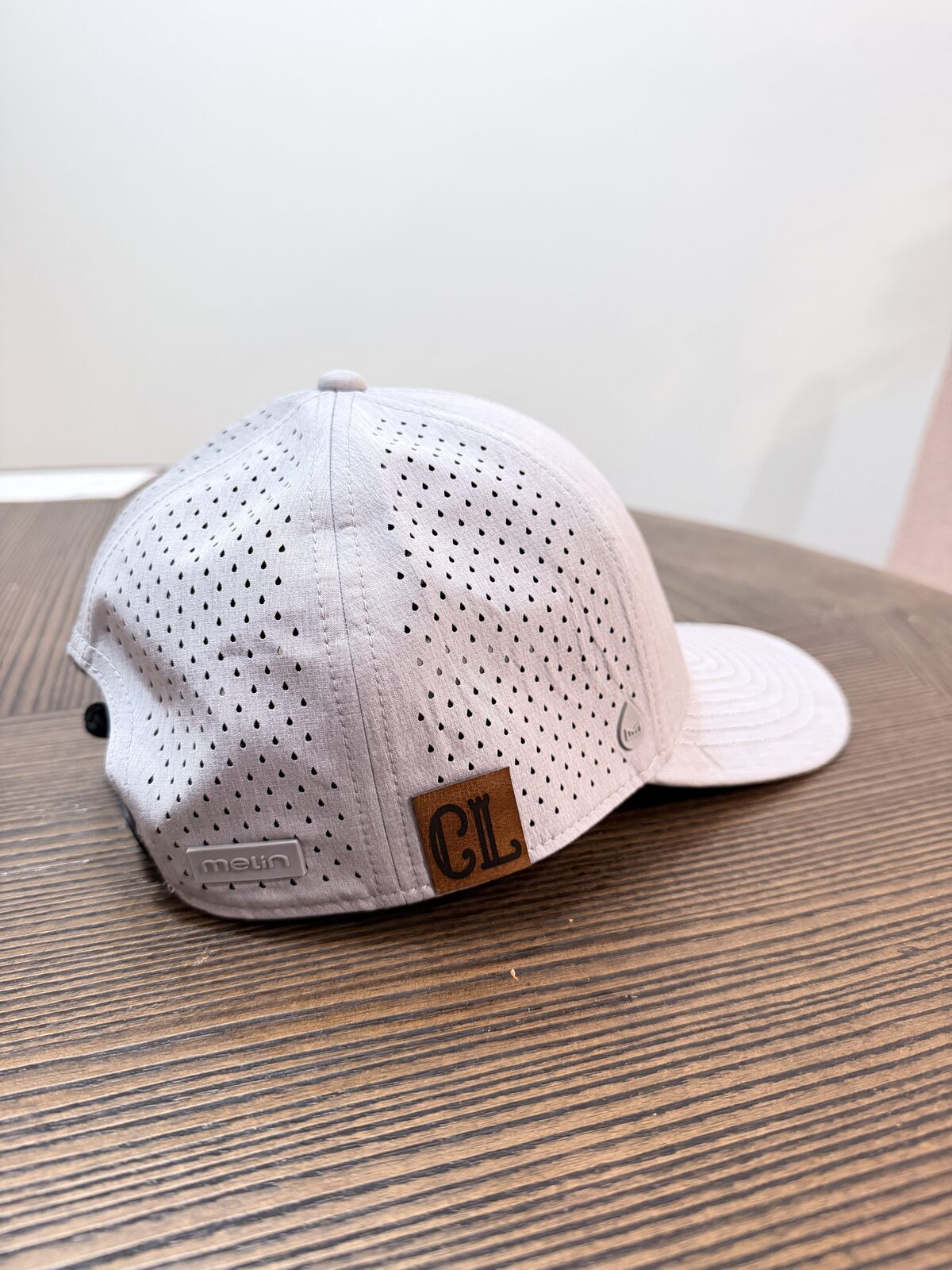 Detail of a leather-patch cap made at a live hat bar